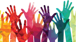 mulitple colored hands reaching skyward