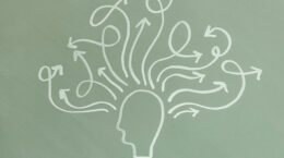 A line drawing of a head with many different arrows coming out going in all directions on an olive colored background.